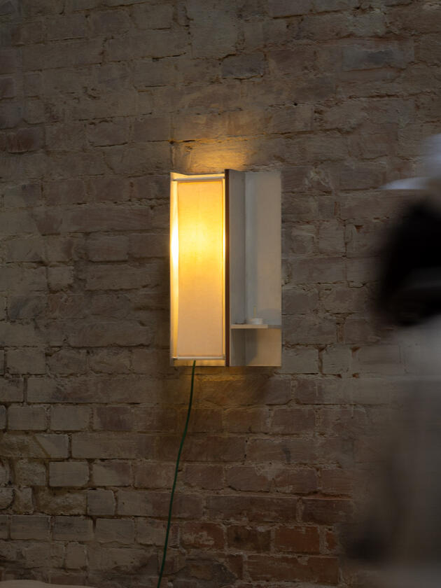 ritual lamp A wall lamp made of hand brushed aluminium with a strip of dark hardwood and a soft calico cover. Designed and made by Liam Barwick