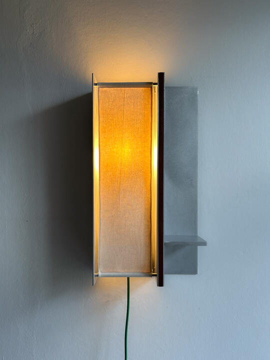ritual lamp A wall lamp made of hand brushed aluminium with a strip of dark hardwood and a soft calico cover. Designed and made by Liam Barwick
